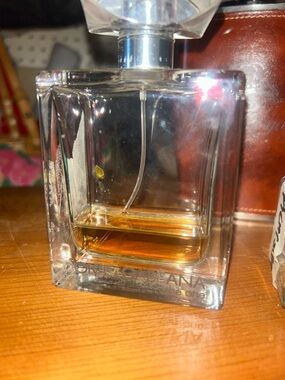 Dolce & Gabbana clear glass bottle with amber liquid